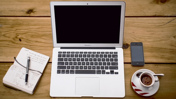 Mac computer and iphone on a table