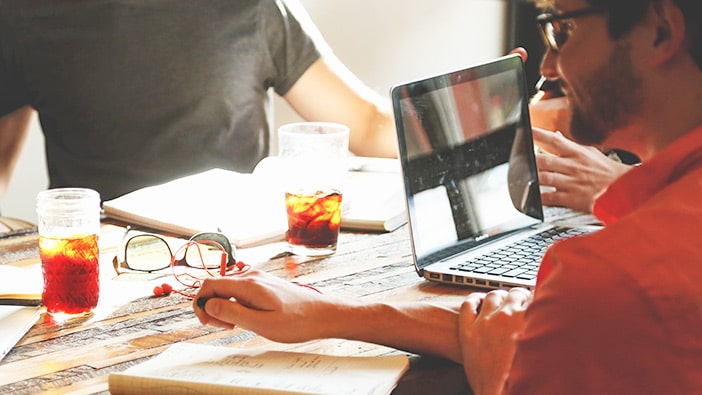 business students working on a startup together